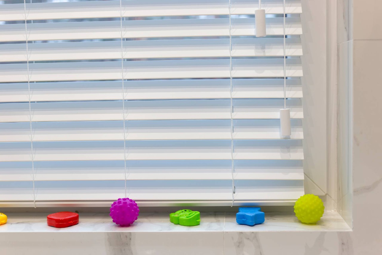 White faux wood blinds in a bathroom at Discount Best Blinds & Shutters near Santa Rosa, CA