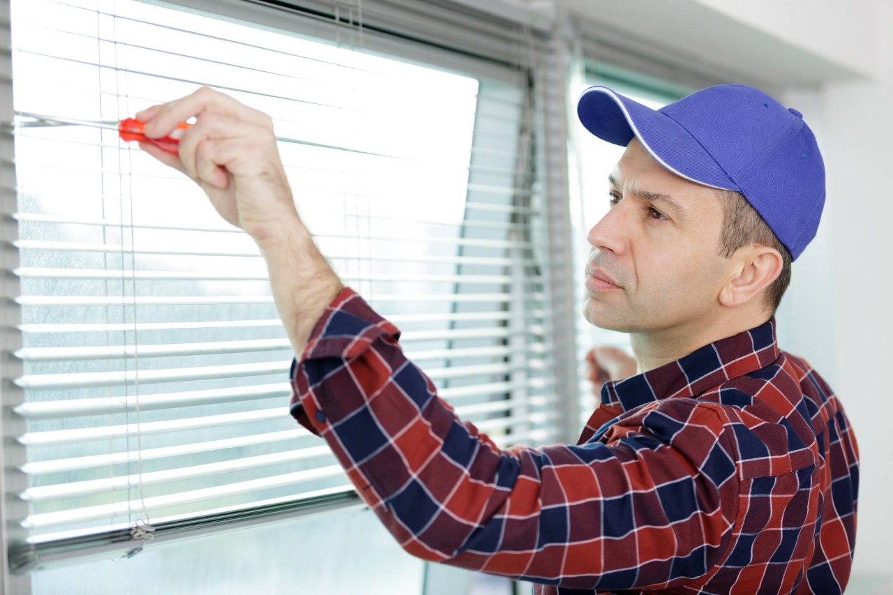 Someone doing final adjustments during a window treatment installation at Discount Best Blinds & Shutters near Santa Rosa, CA